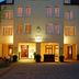 Hotel König Ludwig Ii in Garching bei München, lit facade at dusk with multiple windows and entrance