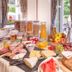 Breakfast buffet at Goldener Adler Oberried - Hotel & Appartements in Oberried with pastries, fruit and bread