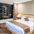 Muong Thanh Luxury Lang Son Hotel room with king bed, desk and large window view in Lang Son