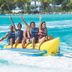 Playa Blanca Beach Resort in Río Hato, guests ride a banana boat on turquoise water