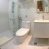 Royal Hotel Taipei City bathroom with shower, toilet, sink, and wall shelf