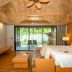 ananea Beyond Khaolak guest room with king bed, balcony view, and wooden loft in Takua Pa