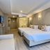 Eurana Boutique Hotel in Chiang Mai guest room with two beds, sofa, and soft wall lighting
