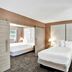 The Garden Hotel & Resort in Fort Lauderdale guest room with two beds and sliding barn doors