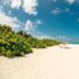 Hondaafushi Island Resort in Hanimaadhoo with white sand beach, turquoise water, and a red umbrella