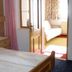 Pension Berggeist in Sölden bedroom with twin beds and open doorway to a bright sitting area