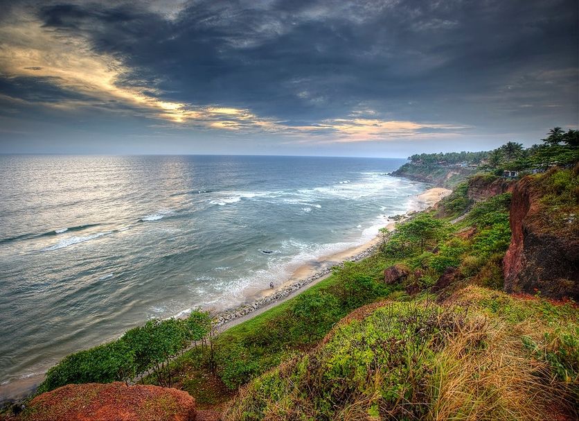 Gateway Varkala overlooks a scenic Varkala beach with ocean waves and a dramatic sunset sky.