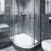 Hotel Uzwil bathroom with glass-enclosed shower, vanity sink and toilet in Uzwil