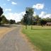 Tocumwal Golf Resort in Tocumwal with a roadside entrance sign beside open green lawns and parking