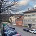 Hotel Berri Versalles in Errenteria, a 2-story hotel beside a sloped street with parked cars and hillside views