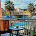 Dolphin Hotel in Skopelos balcony view of pool, palm trees, and surrounding buildings