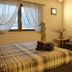 Arbulé Agriturismo & Spa Valtellina room in Poggiridenti with plaid bed, sofa and wall-mounted TV