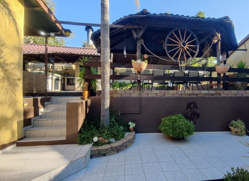 Maison Ambre Guesthouse in Windhoek courtyard with steps, covered patio, and hanging planters