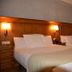 Hostal la Font in Os de Civís, twin guest room with two beds, wood headboard and wall lamps