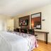 Red Roof Inn Phoenix-Midtown room with king bed, wall-mounted TV and desk in Phoenix