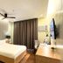 Lenox Hotel in Dagupan City guest room with a bed, bedside lamps, wall TV and desk