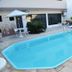 Hotel Steinhausen in Blumenau: outdoor pool with patio seating beside the hotel building