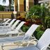 Holiday Inn Express Boca Raton-West by IHG poolside lounge chairs amid tropical landscaping