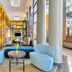 Crowne Plaza Foster City-San Mateo lobby seating area with blue chairs and tall windows in Foster City