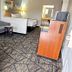 Americas Best Value Inn & Suites Senatobia guest room with sofa, chair, desk, and bed