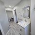 Hillside Inn Pembroke bathroom with white vanity, mirror, and walk-in shower
