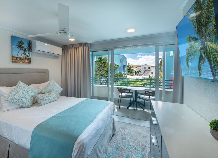 Blue Haven Holiday Apartments in Christchurch bedroom with balcony and garden view