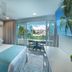 Blue Haven Holiday Apartments in Christchurch bedroom with balcony and garden view