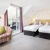 Hawksmoor Guest House Windermere room with twin beds and balcony doors to a seating area