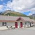 Trailhead Lodging in Seward with mountain backdrop and outdoor seating