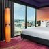 The Rally Hotel at McGregor Square in Denver guest room with city view, king bed, and floor-to-ceiling window