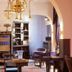 Hotel Boutique Castillo Rojo in Santiago lounge with chandelier, purple seating, bar cabinet and archways