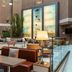 Delta Hotels by Marriott Olbia Sardinia lobby lounge with seating, lamps and tall artwork in Olbia