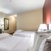 Red Roof Plus Long Island - Garden City Westbury room with two beds and desk