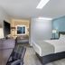 SureStay Plus by Best Western Asheboro guest room with king bed, desk, and blue accent wall