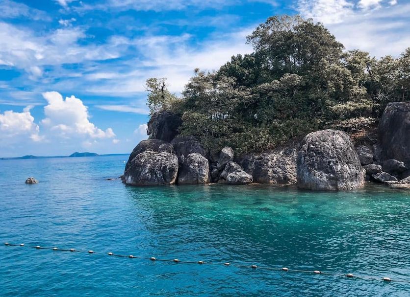 Coconut Beach Resort, Koh Chang with clear turquoise sea and rocky tropical shoreline in Ko Chang