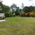 Kinabalu Poring Vacation Lodge in Kundasang, grassy garden with signpost and mountain backdrop
