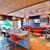 Ibis Les Herbiers bar lounge with chess mural, red seating, foosball table and terrace view