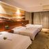 Wuyue Yuexin Hotel (Jinggangshan) guest room in Ji'an with three beds and TV
