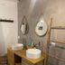 Chambres D'hotes Du Domaine Des Doudous Saint-Pierre bathroom with double sinks, mirrors and towel ladder