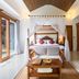 Ashoka Tree Resort at Tanggayuda, Ubud: canopy bed room with balcony view and wooden furniture