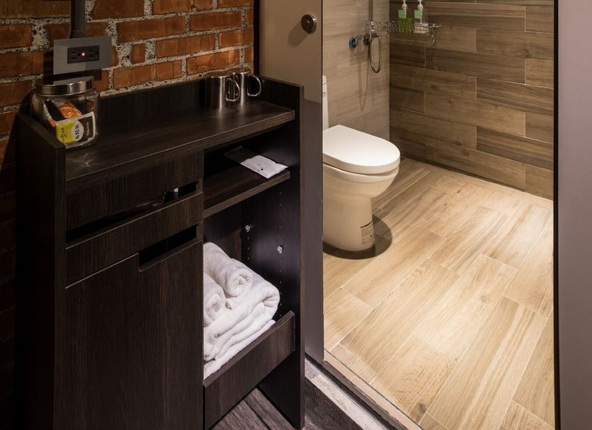 The Brick, Tainan City bathroom with walk-in shower, toilet, and exposed brick wall