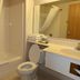 Americas Best Value Inn Annandale bathroom with tub-shower, toilet, sink and mirror