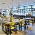 Sercotel Madrid Aeropuerto breakfast restaurant with tables and yellow chairs in Madrid