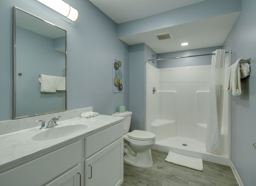 Ocean Lodge Hotel North bathroom in Ocean City with shower, vanity, and toilet