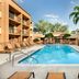 Courtyard by Marriott Fort Myers Cape Coral pool with palm trees and lounge chairs in Fort Myers