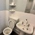 Granby Hotel Scarborough bathroom with toilet, sink, tiled walls, and shower enclosure