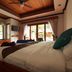 Blue Diamond Resort Ko Tao guest room with king bed, ceiling fan, and balcony doors to pool view