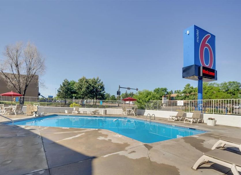 Motel 6 Lakewood, Co - Denver outdoor pool with lounge chairs and blue sky in Lakewood