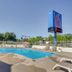 Motel 6 Lakewood, Co - Denver outdoor pool with lounge chairs and blue sky in Lakewood
