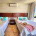 Meliora By Bunik in Playa del Carmen: twin beds with pillows, bedside table, and ocean-view window